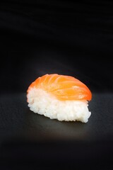 sushi salmon isolated on black background 