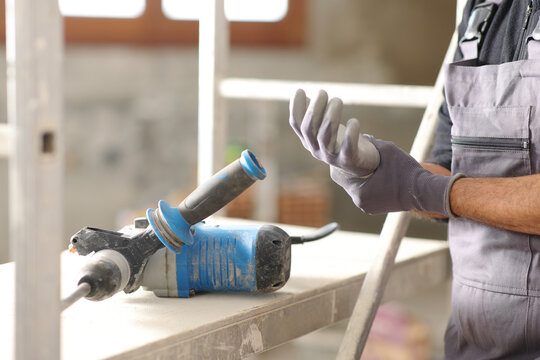 Construction worker suffering wrist ache after using hammer