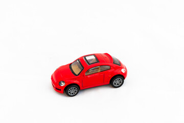 Red toy car on white isolated background with copy space