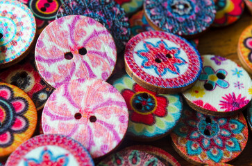 Close-up of coloured buttons on a wooden background
