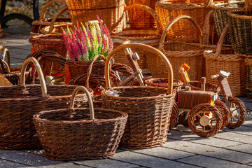 wicker baskets and other decorations at a village market. wicker cars for children © Adam