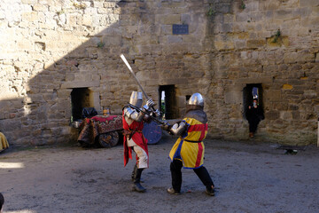 Two medieval knights cosplay a duel in castle