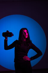 A woman enjoys the world of virtual reality in VR glasses. Virtual reality headset. Artificial intelligence. VR glasses concept. Vertical photo