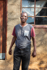 african village, portrait of african man in front of the house