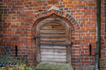 entrance to the grave chapel in an old abandoned cemetery. wooden door leading to the tomb.