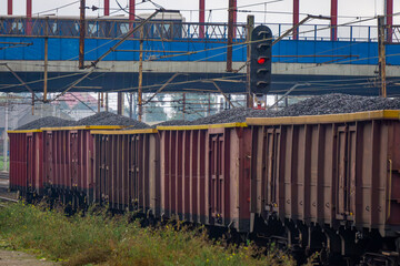 rail transport of coal and coal dust in freight wagons. non-ecological winter fuel. freight train standing at the railway station. wagons full of coal © Adam