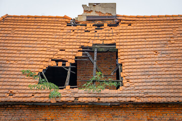 hole in the tiles in the roof of an old abandoned house