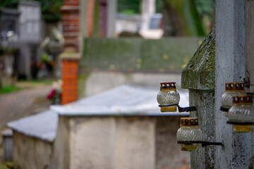 candles standing in the cemetery are not burning. All Saints' Day at the city cemetery. selective focus, blurry background.