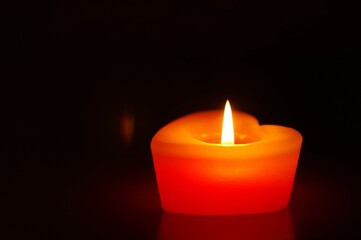 red candle in the dark