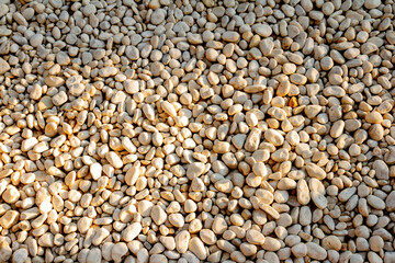 White pebble stones background texture. Close up of stone pebbles.