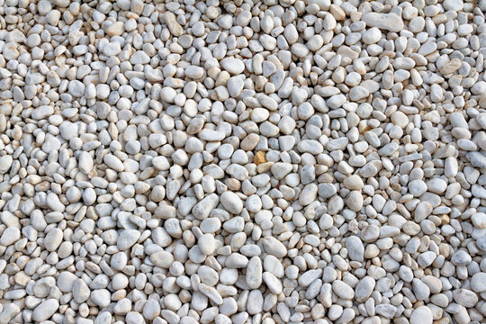White pebble stones background texture. Close up of stone pebbles.