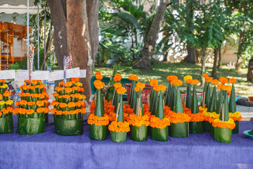Fototapeta premium A handmade sacrificial offering that made from fresh flower and banana leaf to make a merit in the royal Buddhist temple of Wat Xiengthong in Luang Prabang, Laos