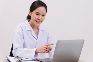 Female doctor sitting at desk in hospital.