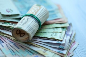 Big amount of different ukrainian hryvnia currency money bills on wooden background