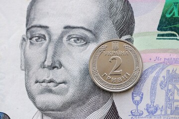 Ukrainian silver coin lies on five hundred hryvnia bill. Financial and business concept. Modern...