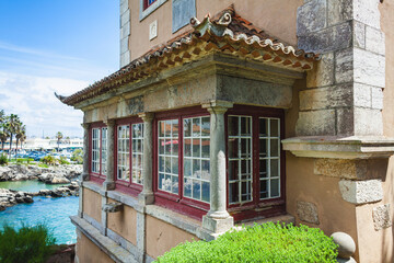 A close-up of a charming building's corner with traditional architectural details, featuring large,...