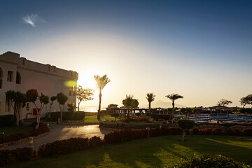 Sharm El Sheikh. Egypt. Beautiful sunset on the hotel grounds. Sunlight. Green grass.