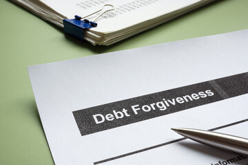 Debt forgiveness form and a stack of papers. Financial relief and debt settlement.