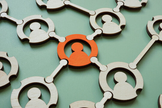 A network of figures with one special figure. Individuality and collaborative environment.