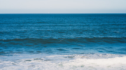 Calm Ocean Waves Under a Clear Blue Sky
