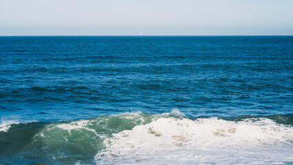 Vibrant Ocean Waves Crashing on a Sunny Beach Day