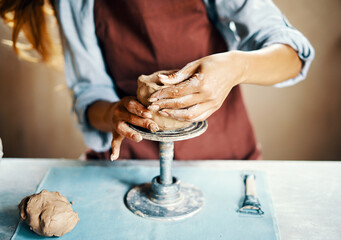 Female artist sculpts crafts with ceramic clay at her creative workshop