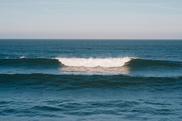 Tranquil Ocean Waves Under Clear Blue Sky