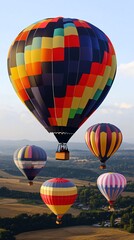 Naklejka premium Colorful hot air balloons soar above a rural landscape.