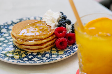 A delectable stack of golden-brown pancakes drizzled with honey