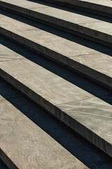 Background shot featuring abstract style of granite or concrete steps in hard light outside in city public space, copy space