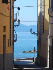 an old street in Piombino with Elba island in the background, Livorno Province, Tuscany, Italy
