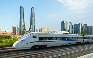 Fototapeta premium High-speed rail speeds on Bridges and the modern city skyline of hangzhou, China