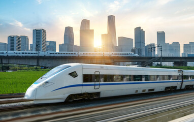 Naklejka premium High-speed rail speeds on Bridges and the modern city skyline of hangzhou, China
