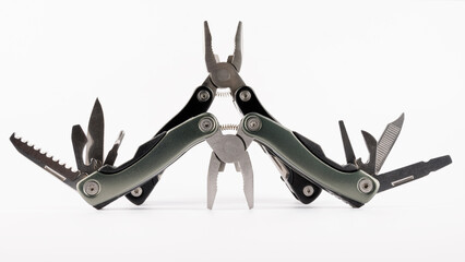 Steel multitool isolated on white background. Opened multitool with pliers, file, blade,...