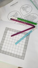 Various math activities on the table, some notebooks and markers