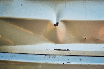 Visible damage on car rear door from an accident, scratches and dents on paint. Trunk door with scratches and dents caused by an impact, bad driving. Paint damage and dent due to collision accident