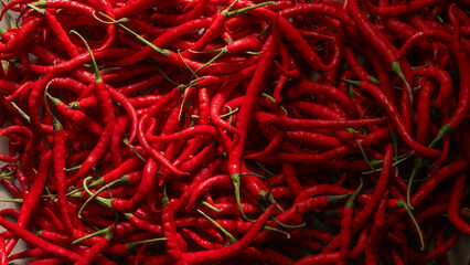 Fototapeta premium Red chili or Capsicum annum L. the shape and pattern of fresh red chilies that fill the screen, red chilies are a plant that is widely cultivated because of its high price