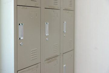 Three metal lockers are lined up against a wall