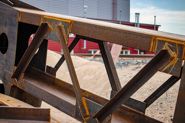 Metal structures stored at an industrial site, showcasing the strong connection points and storage methods in a manufacturing plant
