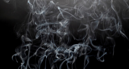 SMOKE ON BLACK BACKGROUND WITH SELECTIVE FOCUS.