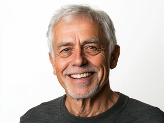 Obraz premium radiant portrait of an elderly man in his sixties, with a bright smile and silver hair, embodying vitality and happiness in his golden years, set against a clean white background