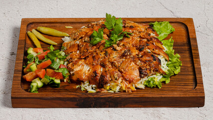 Portion doner kebab with rice on wooden tray