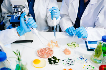 Fototapeta premium Food scientists in lab coats, testing samples, and analyzing food safety and quality in a modern laboratory