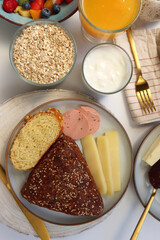 Assortment of various breakfast foods and drinks on the white table. Flat lay.