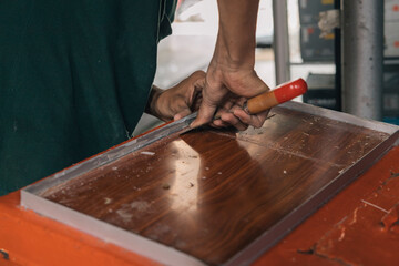 Unrecognizable person preparing a surface where a glass plate is to be installed