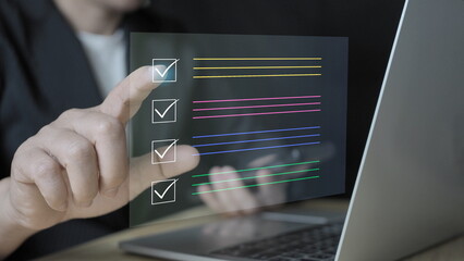 Businessman using laptop online checklist for document approve. acceptance and quality agreement, assurance, correct sign. assessment online survey answer test questions Digital form.