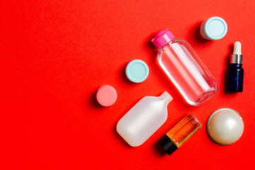 Cosmetics SPA branding mock-up, top view with copy space. set of tubes and jars of cream flat lay on colored background