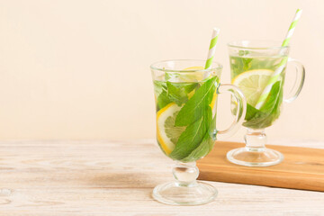 Mojito cocktail. Refreshing mojito cocktail with lime, lemon and mint in a tall glass with a stick
