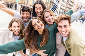Happy group of young people smiling at camera outside - Delightful friends having fun walking in city street - Friendship life style concept