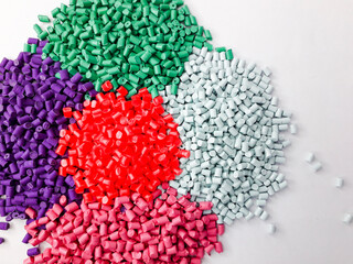 Various colors of masterbatch granules isolated on white background, polymer carriers of color...